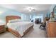 Spacious main bedroom with a king bed, ceiling fan, and an attached office space at 3890 Wilshire Cir # 27, Sarasota, FL 34238