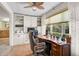 Bright office with built-in shelving, neutral paint, and a large window with a wooded view at 3890 Wilshire Cir # 27, Sarasota, FL 34238