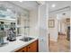 Home wet bar area features mirrored backsplash with glass shelves for glassware storage at 3890 Wilshire Cir # 27, Sarasota, FL 34238
