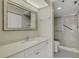 Bright bathroom with white vanity, decorative mirror and a walk-in shower at 3950 Ironwood Cir # 206, Bradenton, FL 34209