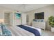 Staged bedroom with carpet, walk-in shower, dresser with TV, and coastal decor at 3950 Ironwood Cir # 206, Bradenton, FL 34209