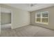 Bedroom with carpet and large window, adjacent room and neutral walls at 3950 Ironwood Cir # 206, Bradenton, FL 34209