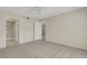 Bright bedroom features neutral walls, carpeting, ceiling fan, and ensuite bath with walk-in shower at 3950 Ironwood Cir # 206, Bradenton, FL 34209
