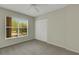Light, neutral bedroom featuring a closet and large window overlooking exterior of building at 3950 Ironwood Cir # 206, Bradenton, FL 34209