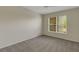 Neutral bedroom featuring large window with blinds, plush carpet, and neutral paint at 3950 Ironwood Cir # 206, Bradenton, FL 34209