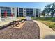 Inviting community space with picnic tables, seating, and walking path, perfect for relaxing or socializing at 3950 Ironwood Cir # 206, Bradenton, FL 34209