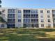 Condo exterior with large grassy area and screened balconies at 3950 Ironwood Cir # 206, Bradenton, FL 34209