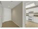 Hallway with tile floors, a front door, and a kitchen with white appliances at 3950 Ironwood Cir # 206, Bradenton, FL 34209