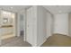 Hallway with carpeted and tiled floors leads to bathroom, bedroom and front door at 3950 Ironwood Cir # 206, Bradenton, FL 34209
