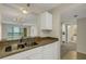 Kitchen with stainless steel sink, view to the sliding glass doors and neutral colored countertops at 3950 Ironwood Cir # 206, Bradenton, FL 34209