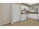 Kitchen featuring white cabinets, stainless steel sink, tile floors, neutral countertops and appliances at 3950 Ironwood Cir # 206, Bradenton, FL 34209