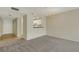 Open-plan living space with carpet, light colored walls and view into the kitchen at 3950 Ironwood Cir # 206, Bradenton, FL 34209