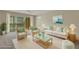 Stylishly furnished living room featuring wicker furniture and a glass coffee table creating a cozy atmosphere at 3950 Ironwood Cir # 206, Bradenton, FL 34209