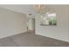 Open-plan living space with carpet, light colored walls and view into the kitchen at 3950 Ironwood Cir # 206, Bradenton, FL 34209