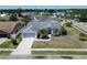 Aerial view of a single-Gathering home with a well-maintained lawn and a two-car garage at 4033 Dover E Dr, Bradenton, FL 34203