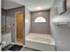 Bathroom with tub, tile shower, and small window at 4033 Dover E Dr, Bradenton, FL 34203