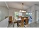 Dining area with modern wood table, chairs, and view of the backyard at 4033 Dover E Dr, Bradenton, FL 34203