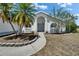 Charming home with a well-manicured front yard, mature trees, and a welcoming entryway at 4033 Dover E Dr, Bradenton, FL 34203