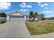 Well-maintained home featuring a two-car garage, landscaped front yard, and a spacious driveway at 4033 Dover E Dr, Bradenton, FL 34203