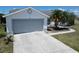 Well-maintained home featuring a two-car garage, landscaped front yard, and a spacious driveway at 4033 Dover E Dr, Bradenton, FL 34203