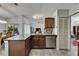 Open kitchen with granite counters, stainless steel appliances, and view into the living room at 4033 Dover E Dr, Bradenton, FL 34203