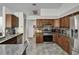 Kitchen with stainless steel appliances, tile backsplash, and dark wood cabinets at 4033 Dover E Dr, Bradenton, FL 34203