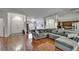 Spacious living room with hardwood floors, gray sofa, and plenty of natural light at 4033 Dover E Dr, Bradenton, FL 34203