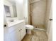 Well-lit bathroom featuring a stand up shower, updated vanity and new toilet at 4058 Gatewood Dr, Sarasota, FL 34232