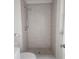 Bathroom featuring shower with tiled walls and floor, with marble-look baseboard at 4058 Gatewood Dr, Sarasota, FL 34232