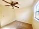 Well-lit bedroom featuring neutral walls, carpeted floors, and a ceiling fan, offering a cozy and inviting space at 4058 Gatewood Dr, Sarasota, FL 34232