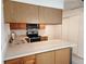 Functional kitchen featuring wooden cabinets, modern appliances, and a convenient breakfast bar at 4058 Gatewood Dr, Sarasota, FL 34232