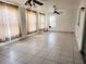 Expansive living area with tiled flooring, neutral walls, and multiple windows, offering versatile space at 4058 Gatewood Dr, Sarasota, FL 34232
