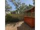 Cozy backyard featuring a tiki bar, storage box, wooden fence, and brick pavers at 4923 25Th W St # 104, Bradenton, FL 34207