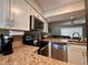 Bright kitchen featuring granite countertops, stainless steel appliances, and seamless layout at 4923 25Th W St # 104, Bradenton, FL 34207