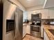 Stylish kitchen with stainless steel appliances, granite countertops, and ample storage space at 4923 25Th W St # 104, Bradenton, FL 34207