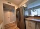 Kitchen with stainless steel refrigerator and breakfast bar access to dining area at 4923 25Th W St # 104, Bradenton, FL 34207