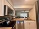 Well-lit kitchen with granite countertops, stainless steel appliances, and open layout at 4923 25Th W St # 104, Bradenton, FL 34207