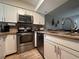 Modern kitchen featuring stainless steel appliances, granite countertops, and white cabinets at 4923 25Th W St # 104, Bradenton, FL 34207