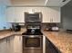 Spacious kitchen featuring stainless steel appliances and ample countertop space for meal preparation at 4923 25Th W St # 104, Bradenton, FL 34207