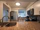 Well-equipped kitchen featuring stainless steel appliances and granite countertops overlooking living area at 4923 25Th W St # 104, Bradenton, FL 34207