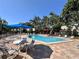 Community pool with lounge chairs and umbrella shaded tables for resident enjoyment at 4923 25Th W St # 104, Bradenton, FL 34207