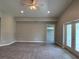 Open living room with neutral paint, ceiling fan, and access to outdoor patio at 5082 Rilke Ln, Port Charlotte, FL 33981