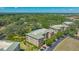 Scenic aerial view of the apartment complex surrounded by lush landscaping and a tranquil pond at 5242 Manorwood Dr Dr # 3A, Sarasota, FL 34235