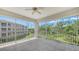 A tiled screened-in balcony, with lush greenery views and beautiful landscaping at 5242 Manorwood Dr Dr # 3A, Sarasota, FL 34235
