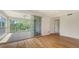 A spacious tiled balcony with a screen overlooking lush greenery and trees at 5242 Manorwood Dr Dr # 3A, Sarasota, FL 34235
