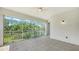 Covered and screened-in tiled balcony, offering serene views of lush greenery at 5242 Manorwood Dr Dr # 3A, Sarasota, FL 34235