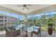 Enjoy outdoor dining on this spacious screened balcony with seating and green views at 5242 Manorwood Dr Dr # 3A, Sarasota, FL 34235