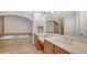 Bright bathroom features a soaking tub, walk-in shower, double vanity, and elegant marble countertops at 5242 Manorwood Dr Dr # 3A, Sarasota, FL 34235