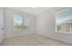 Bright bedroom with neutral carpet, two windows and natural light offers comfortable living space at 5242 Manorwood Dr Dr # 3A, Sarasota, FL 34235