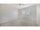 Well-lit bedroom features neutral carpet, a window with blinds, and an overhead ceiling fan at 5242 Manorwood Dr Dr # 3A, Sarasota, FL 34235